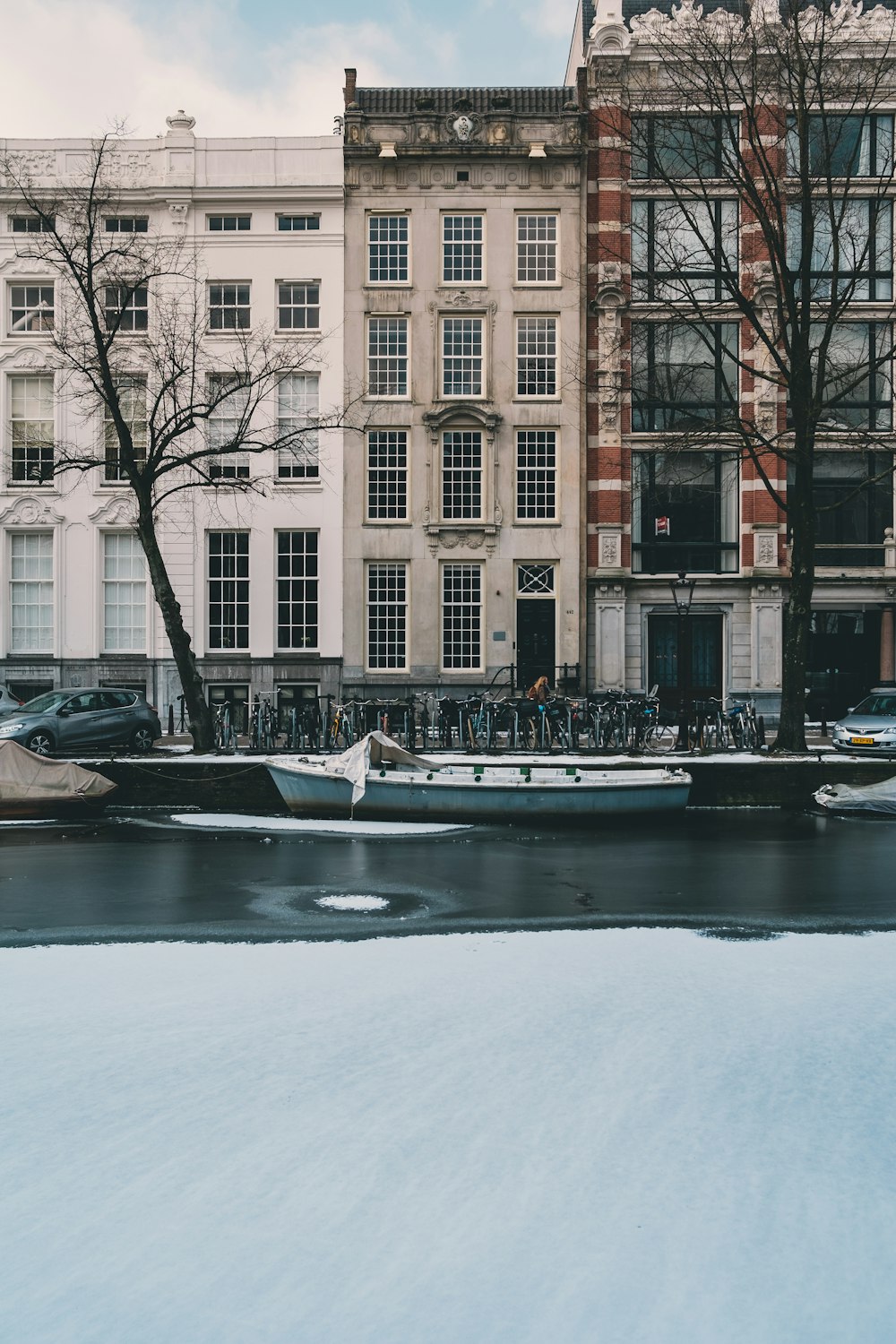 boat parked near road and concrete building