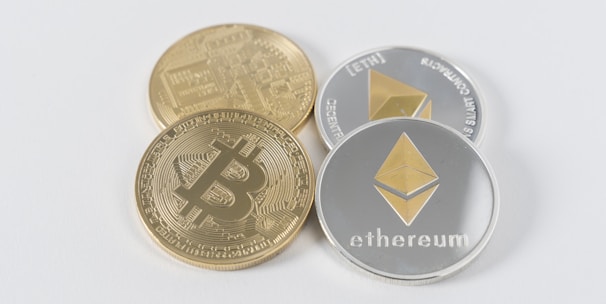 four round silver-colored and gold-colored Bitcoins