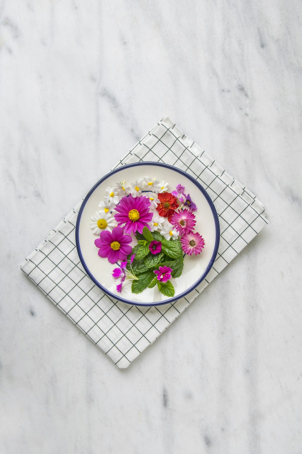 흰 접시에 분홍색 꽃잎 꽃