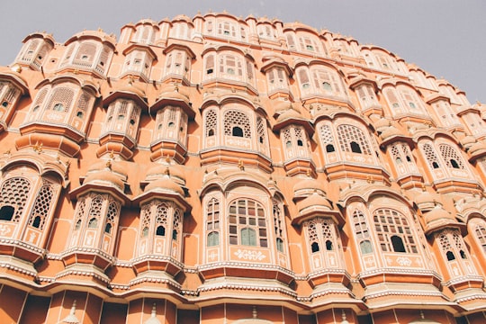 low angle photo of beige concrete building in Hawa Mahal India