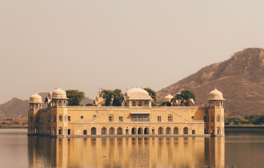 square brown structure in middle of water in Jal Mahal India