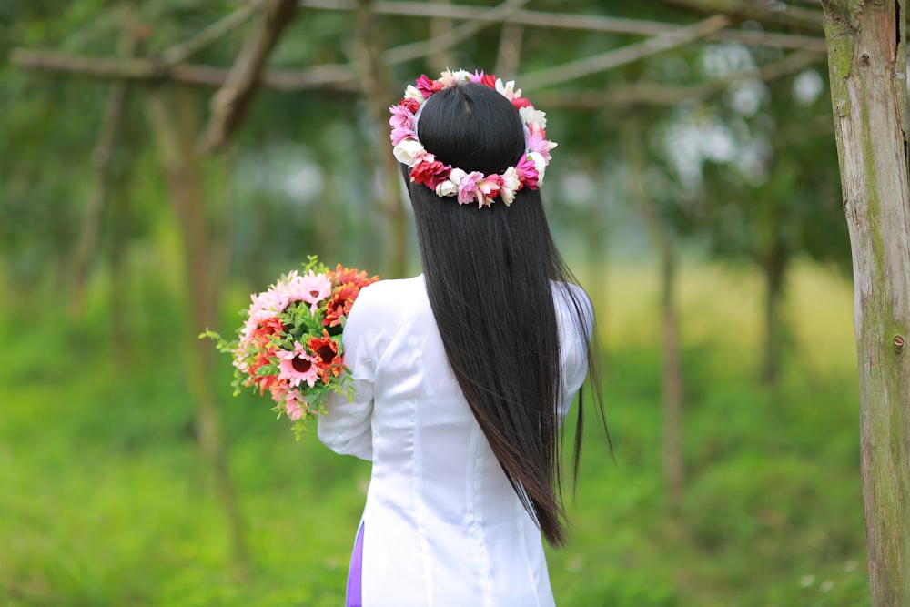 woman facing the other side holding flowers