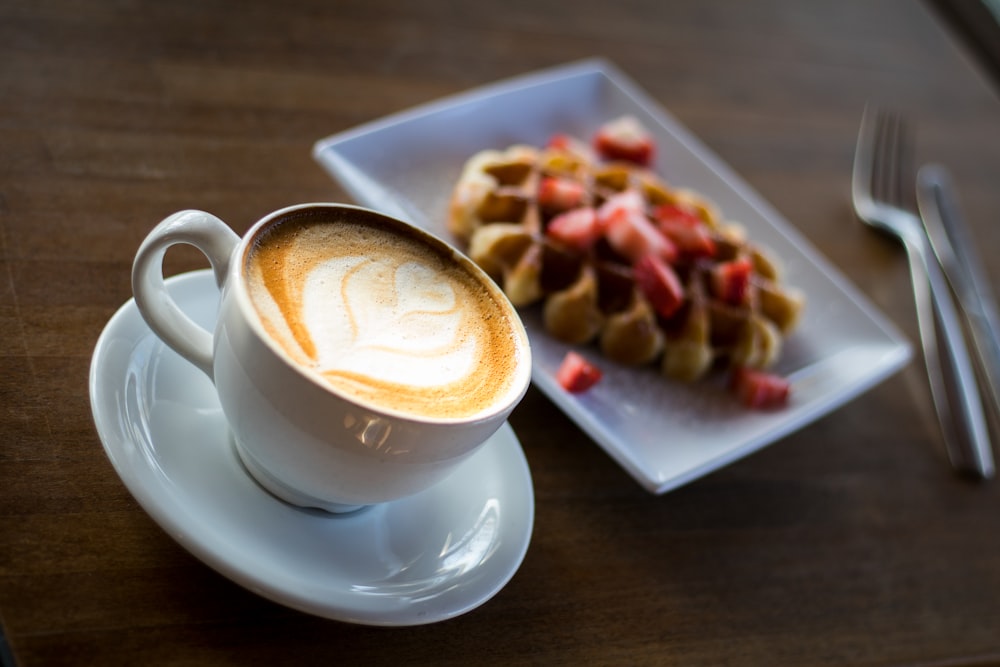 white ceramic cup on table