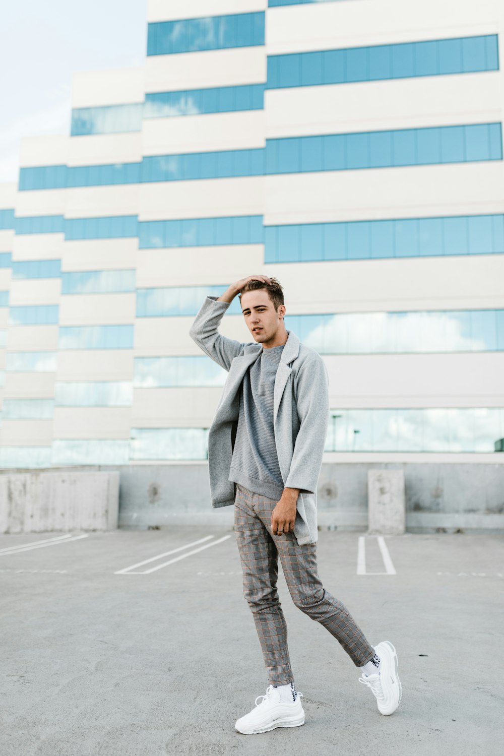 man wearing gray shirt, pants and coat