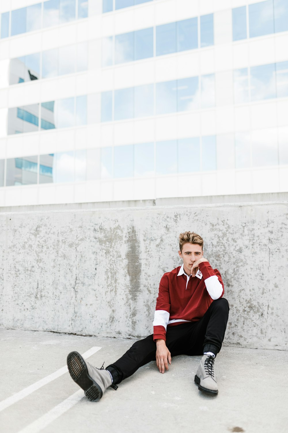 person sitting on white concrete flooring