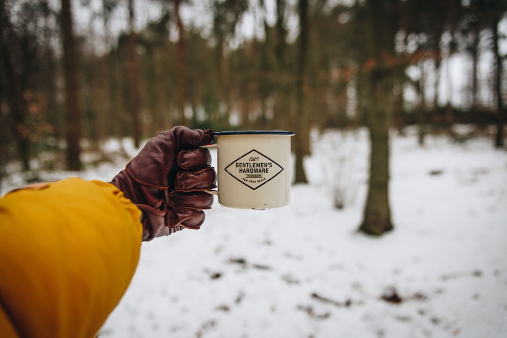 person holding camping mug