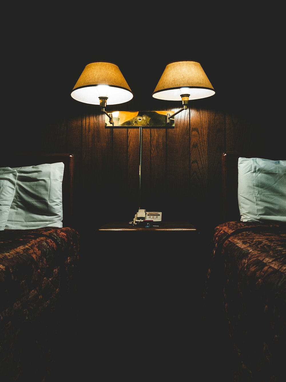 wall lamp in between of beds
