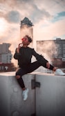 woman sitting on white wall outdoor