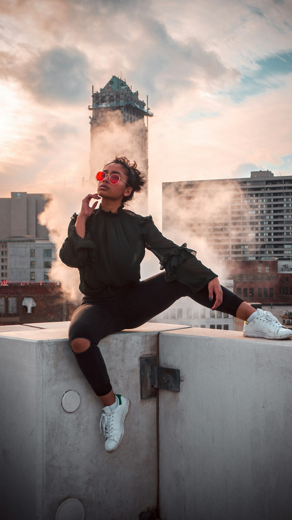 woman sitting on white wall outdoor