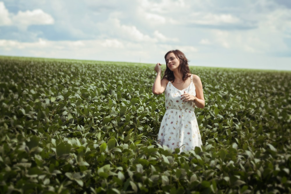 woman standing in green leafed plant field during daytime