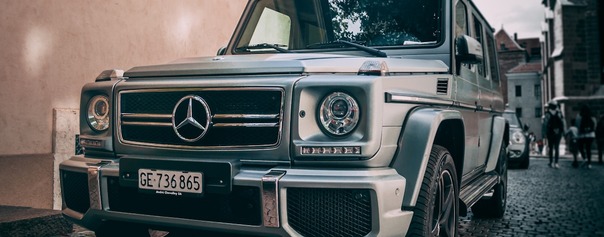 gray Mercedes-Benz vehicle beside house