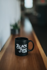 black Black Ring Coffee ceramic coffee mug on brown wooden surface