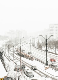 aerial view of road coated snow with vehicle passes