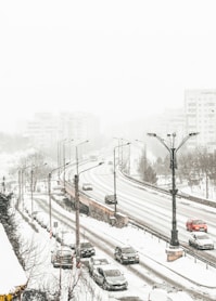 aerial view of road coated snow with vehicle passes