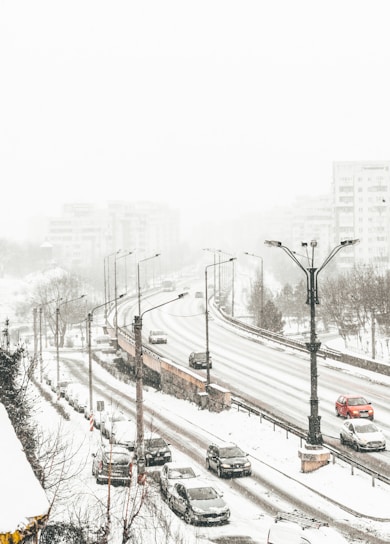 aerial view of road coated snow with vehicle passes