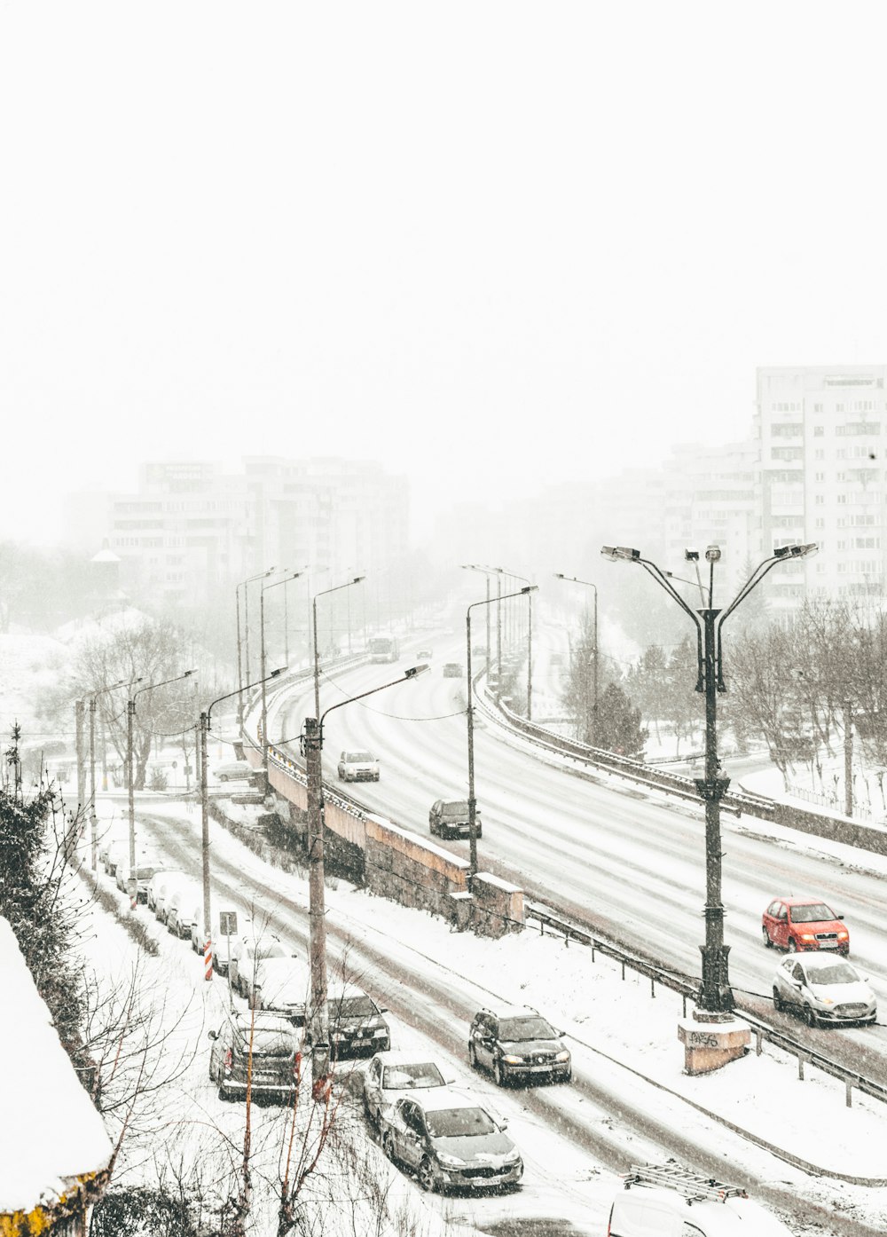 aerial view of road coated snow with vehicle passes