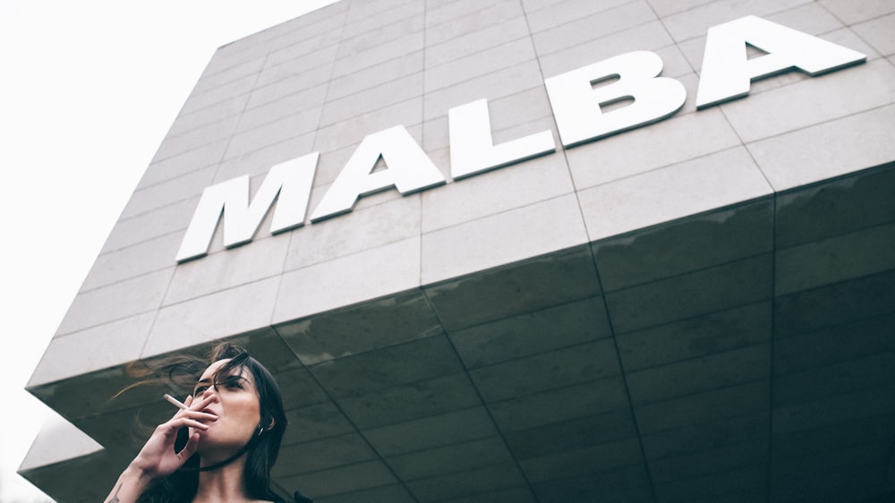 woman taking cigarette near Malba building