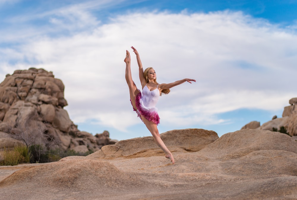 woman doing exercise on mountain