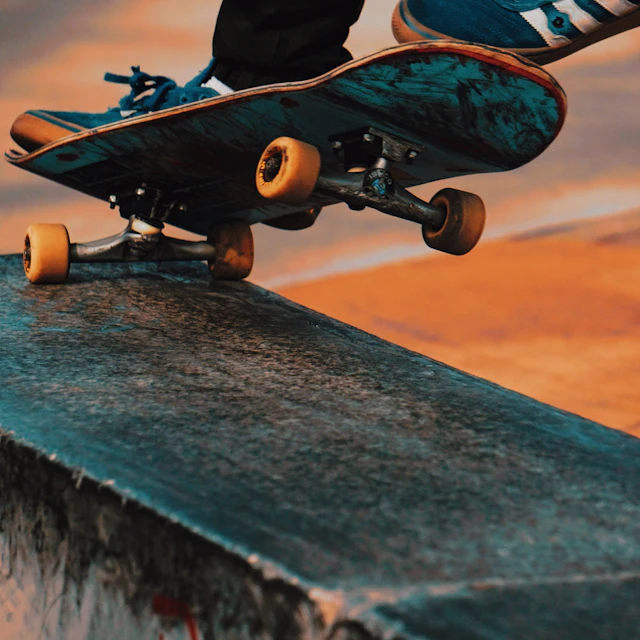 A skateboarder in mid air doing a kickflip trick