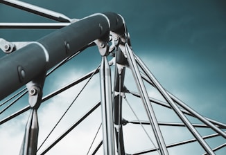 a close up of a metal structure against a cloudy sky