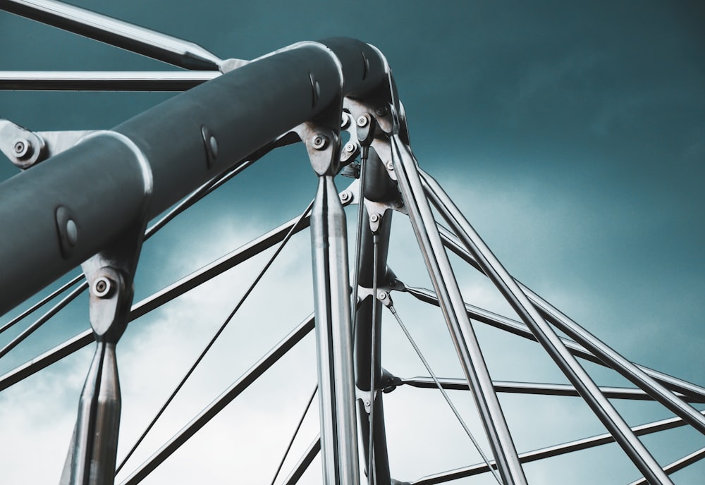 a close up of a metal structure against a cloudy sky