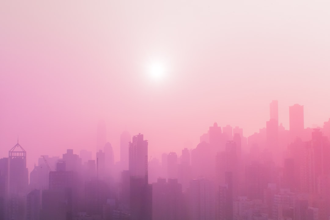 skyscraper covered with fog at daytime,