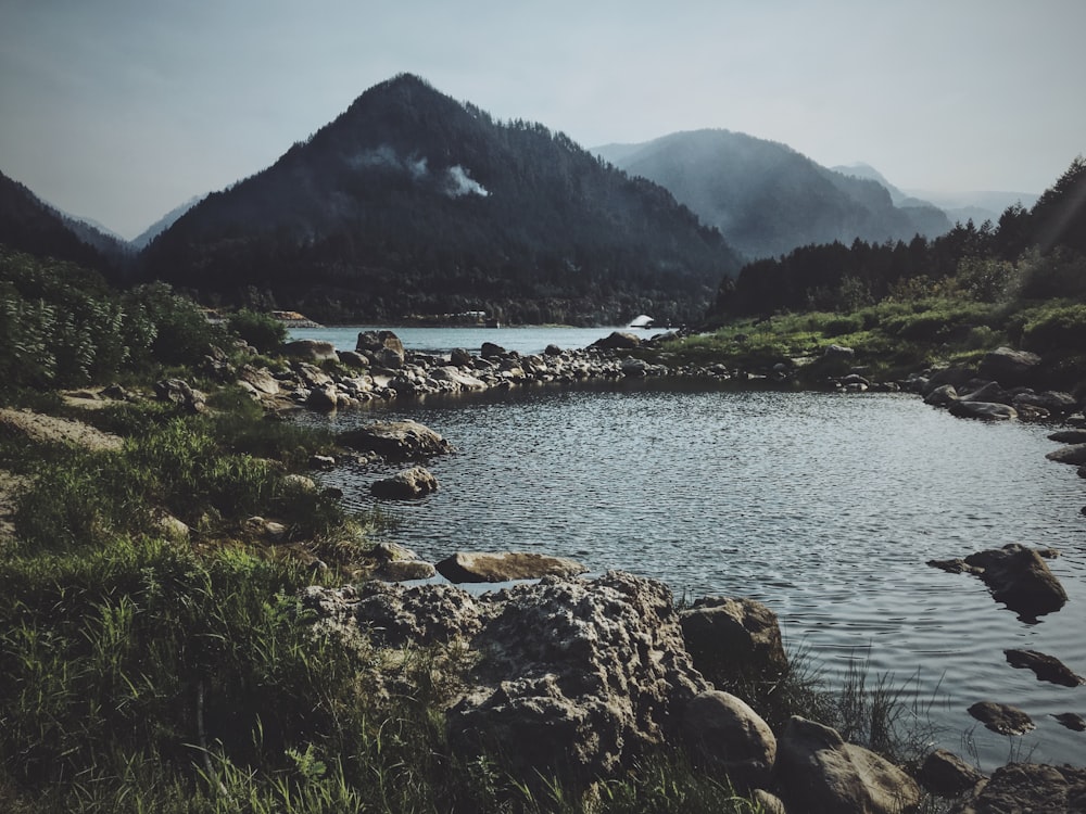 body of water surrounded by mountains