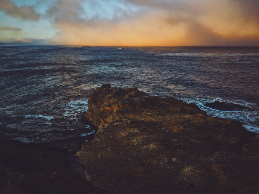 brown rock mountain near ocean