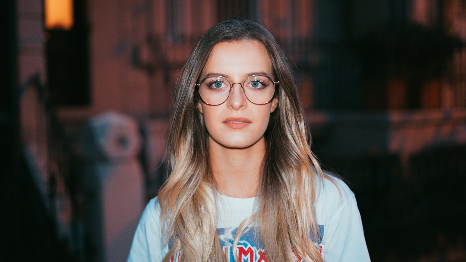 Sony a7R + Sony FE 50mm F1.8 sample photo. Woman wearing eyeglasses standing photography