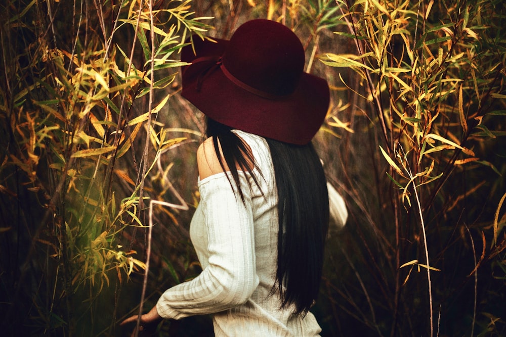 woman standing in between plants