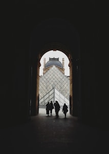 silhouette of people walking out of door