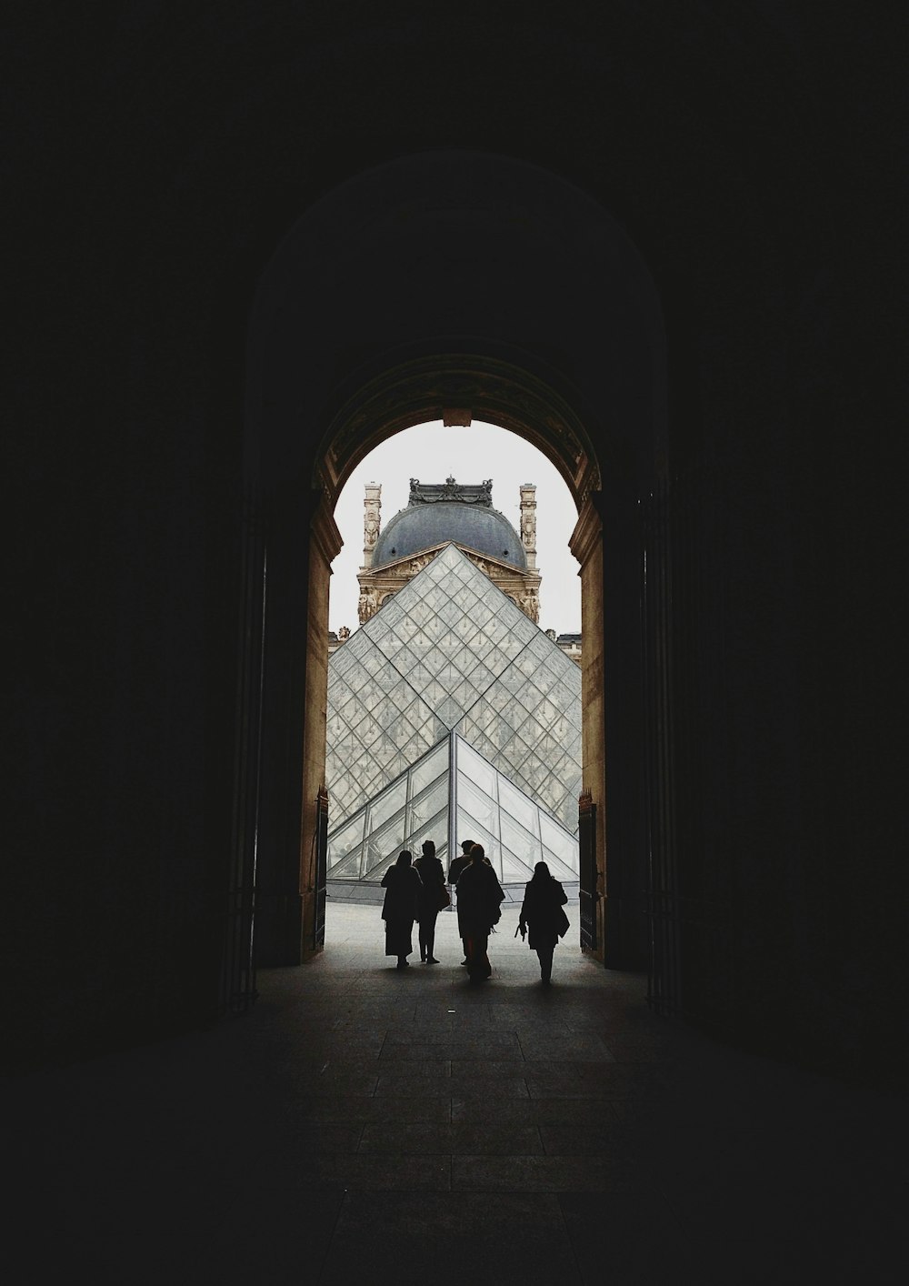 silhouette of people walking out of door