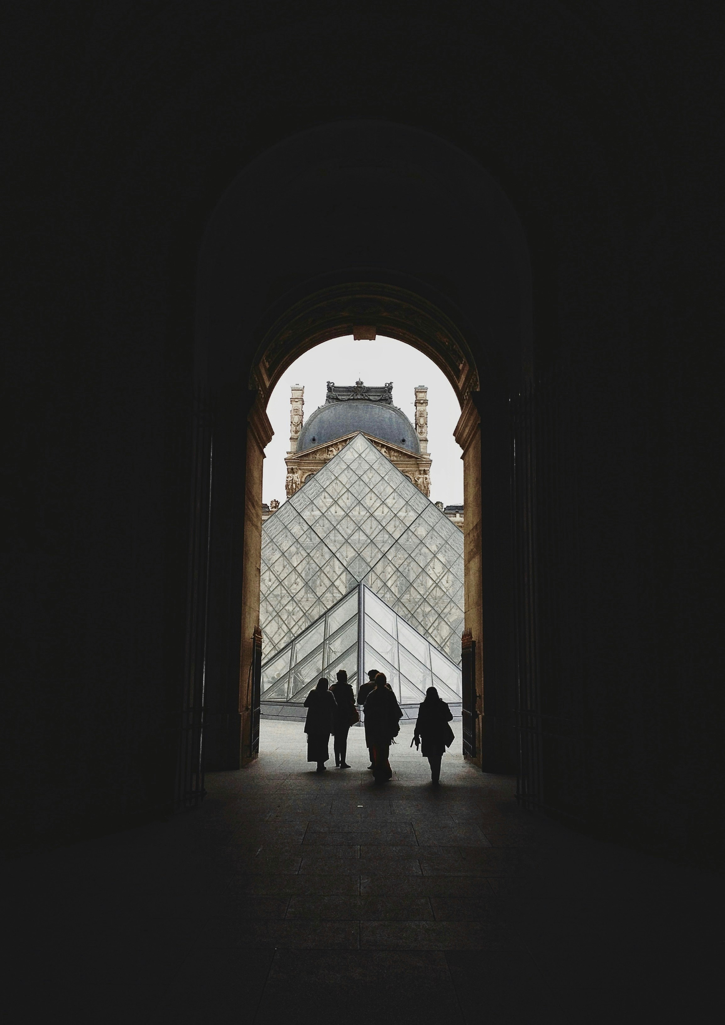 silhouette of people walking out of door