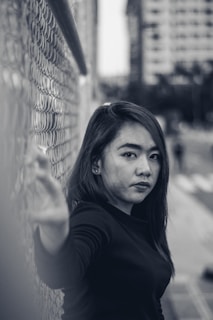 Portrait of Fanny Tittel Mosser, PhD, in a thoughtful pose with a backdrop of international flags symbolizing migration and development.