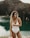 woman in white swimsuit standing near body of water