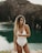 woman in white swimsuit standing near body of water