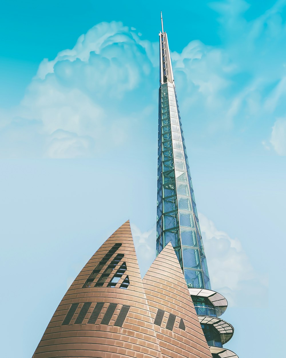 low angle photography of curtain-wall tower building under blue skies during daytime