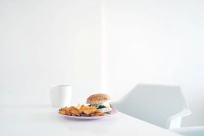A minimalist, clean stainless steel table with a black and white kitchen background.
