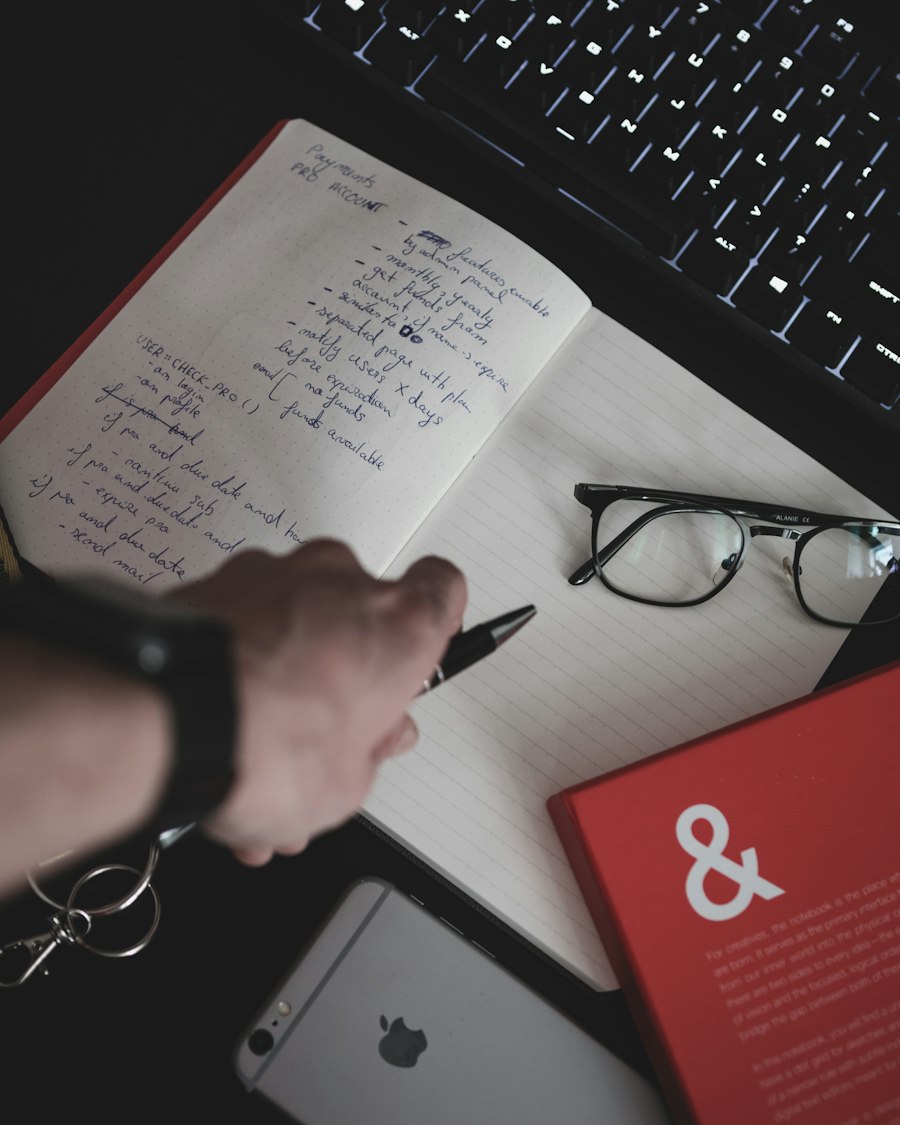 Handwritten notes, glasses and a pen on an open notebook