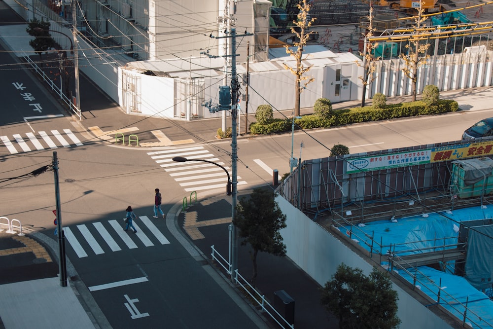 man and woman crossing pedestrian lane