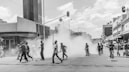 grayscale photo of people on street near buildings during daytime