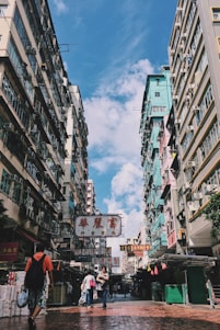 A vibrant street scene in Beijing with traditional architecture and bustling local life under a clear sky.