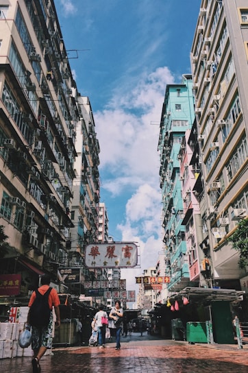 A vibrant street scene in Beijing with traditional architecture and bustling local life under a clear sky.