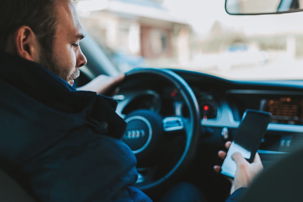 man holding black smartphone