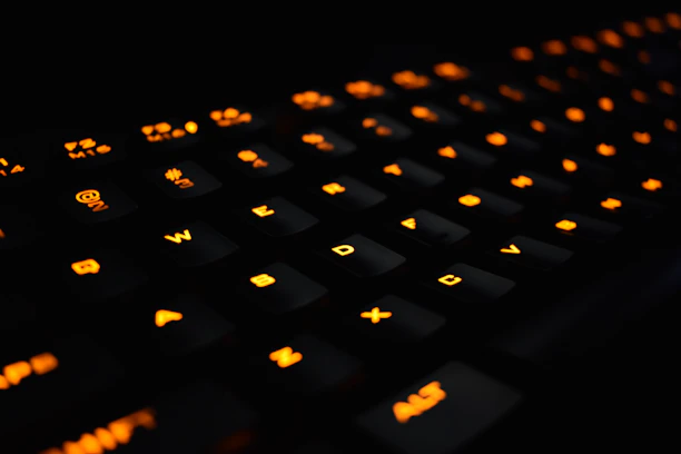 Close-up of hands typing on a keyboard with a sleek orange and black color palette background.