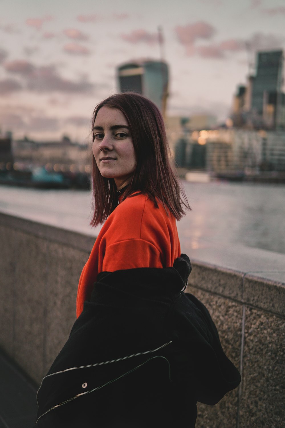 woman standing in front of view of cityscape