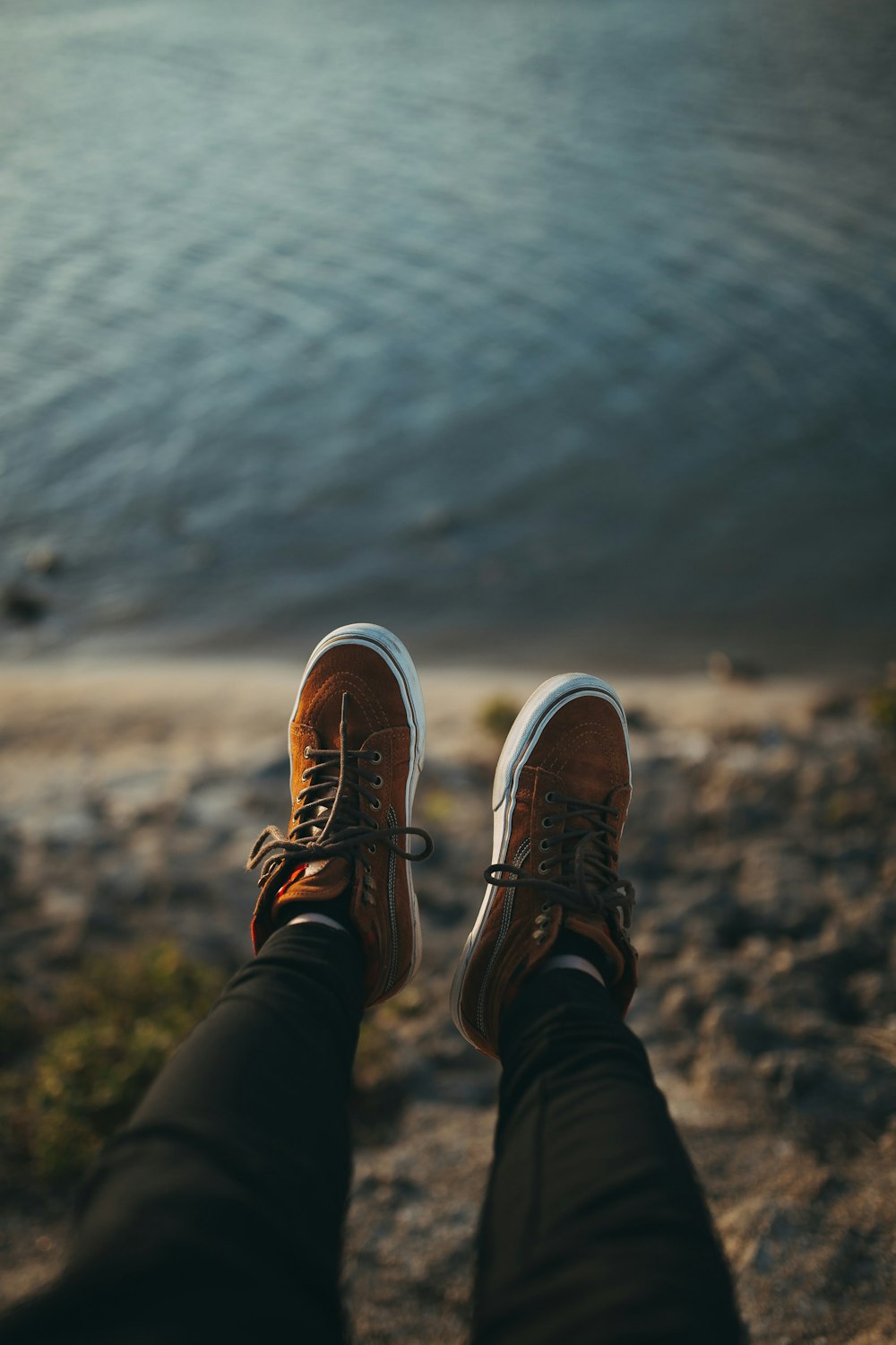 person sitting on mountain cliff