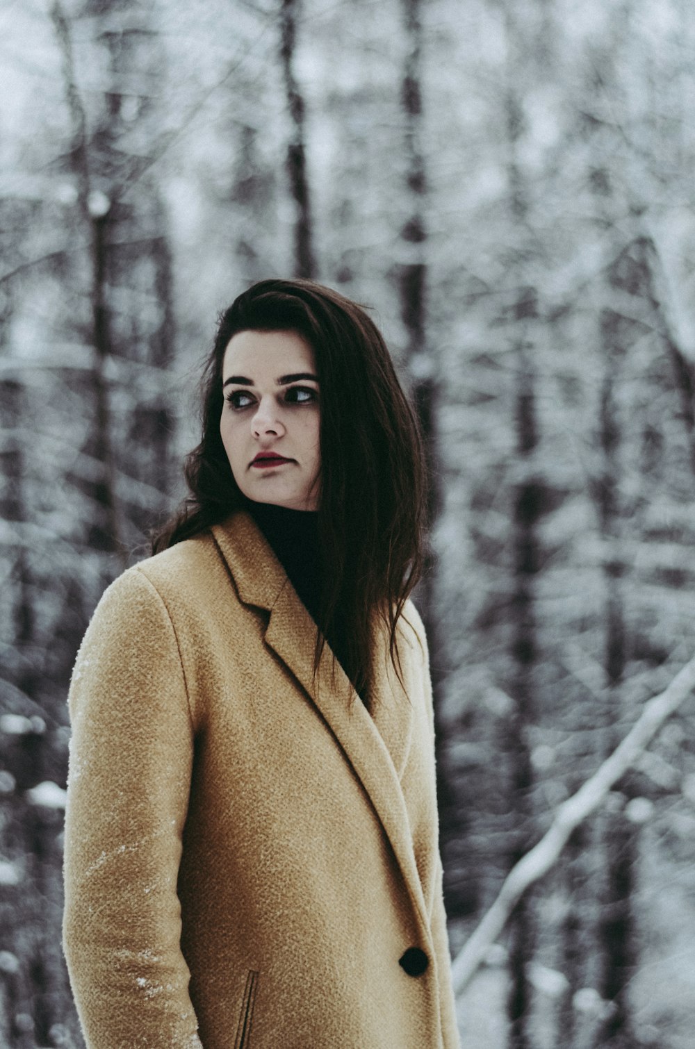 shallow focus photography of woman standing near treest