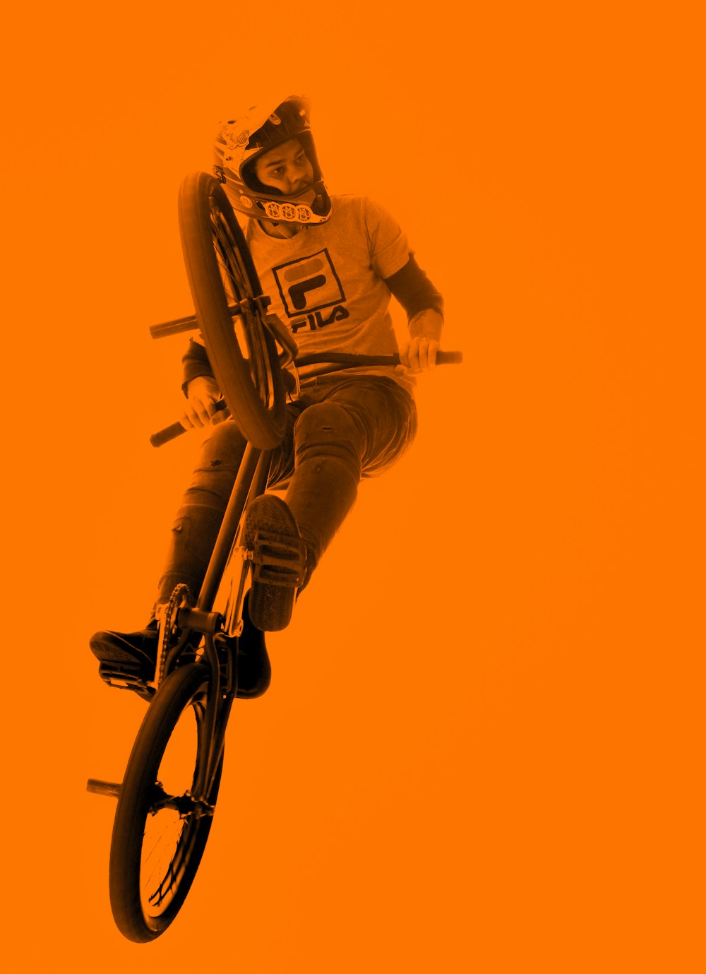 man riding BMX bicycle while doing tricks