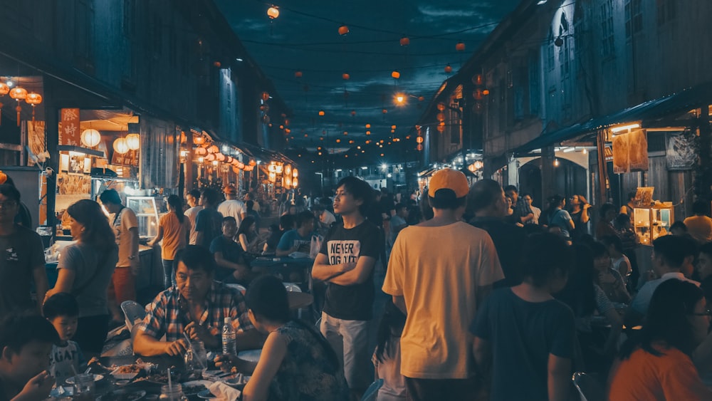 people gathering near street food stalls